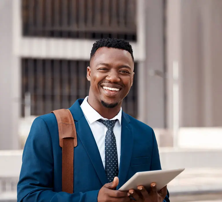 Regent University student smiling with a tablet in hand