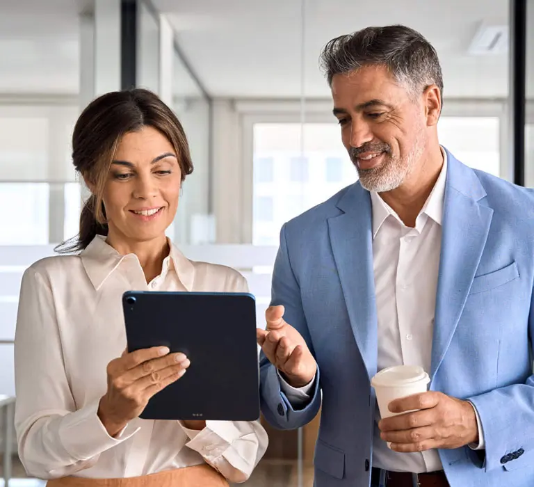 Guy pointing to notes holding coffee