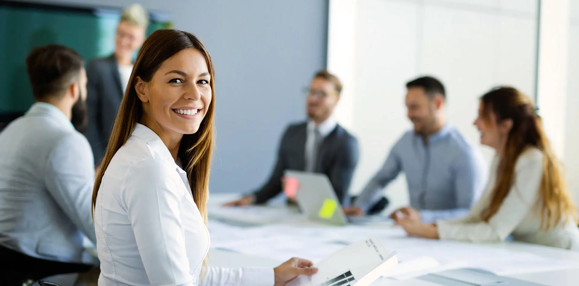 Business people at conference room one smiling