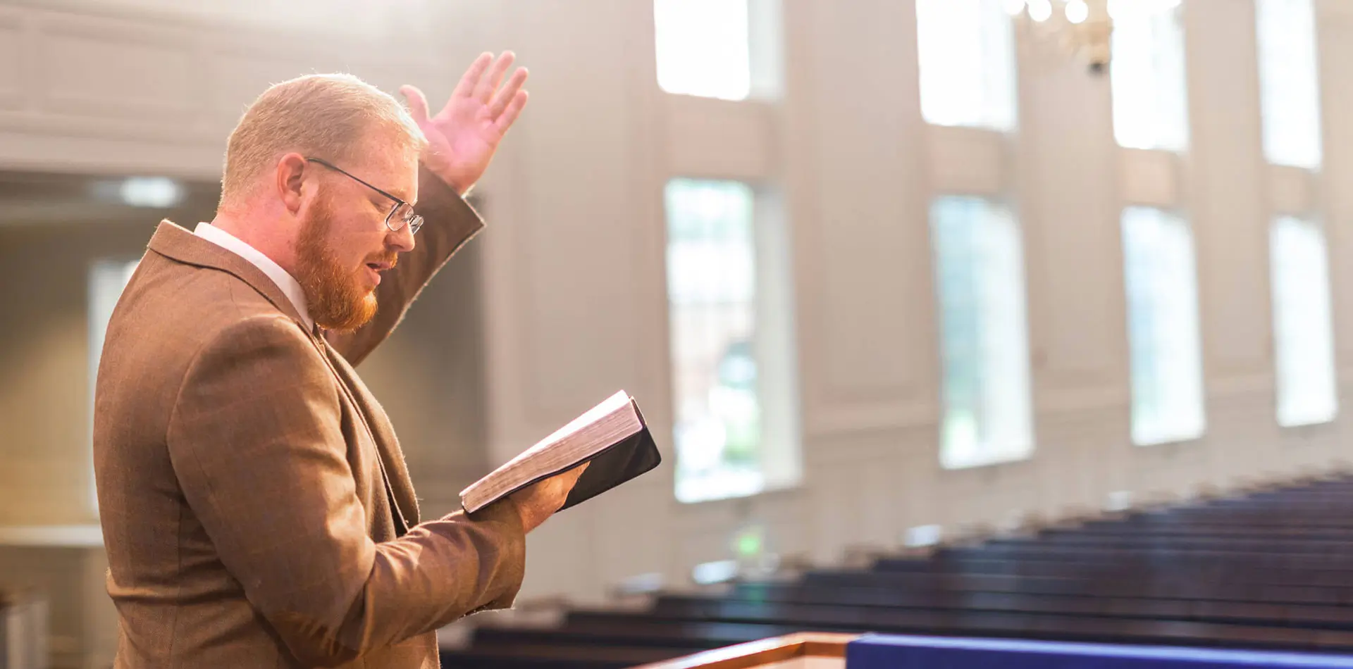 Man in chapel reading scripture