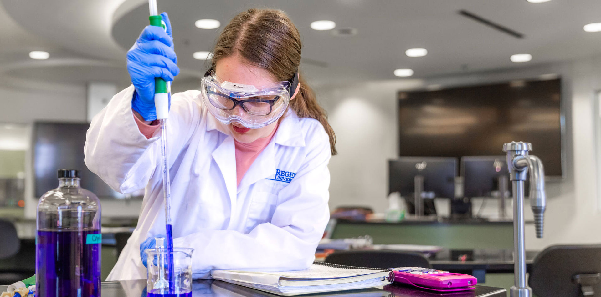 Science teacher experimenting in a lab